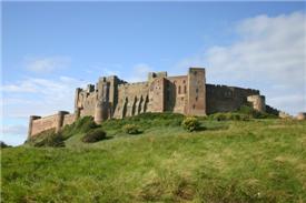 castle perched high on a hill - bamburgh castle